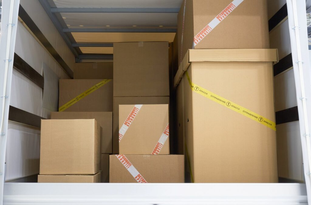 Roll up door open with boxes and furniture in the doorway.